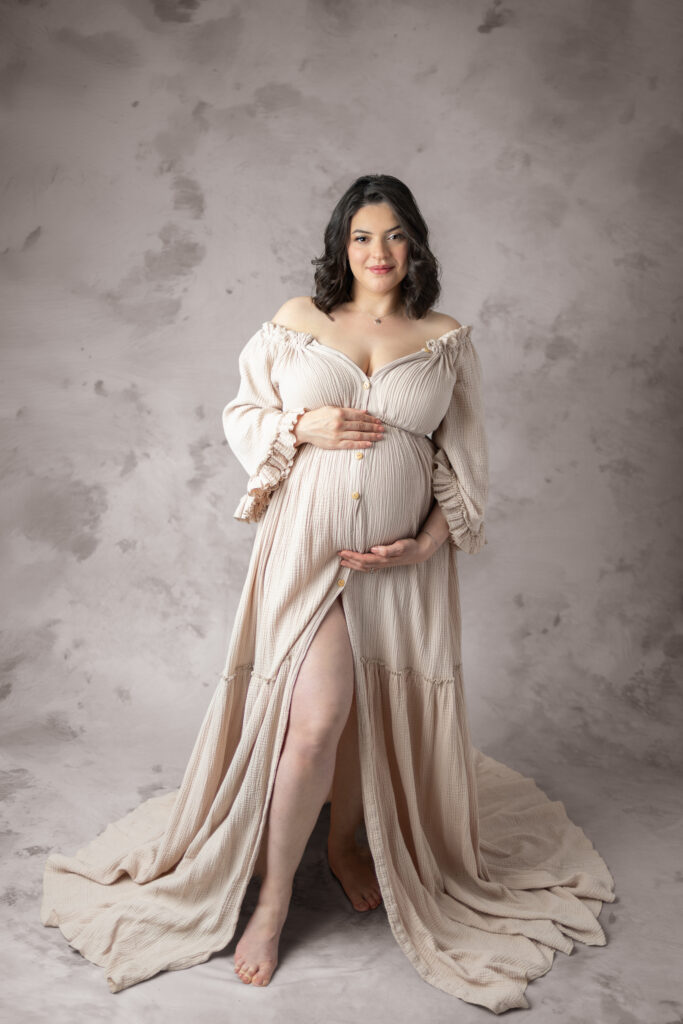 Clifton, NJ maternity photography featuring an expectant mother in a neutral gown with floral hair detail.