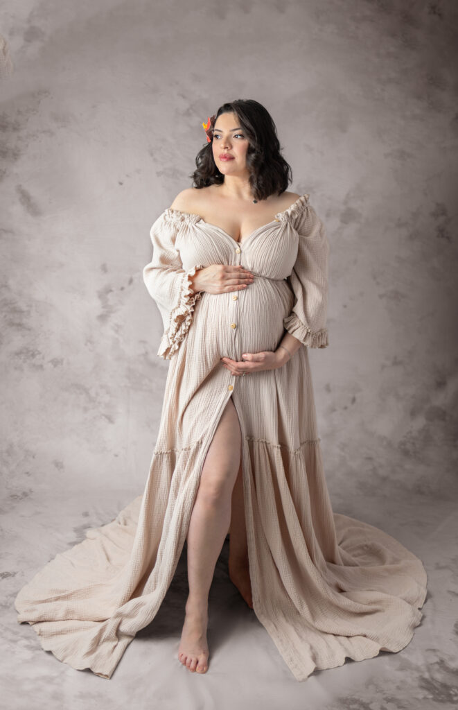 Clifton, NJ maternity photography featuring an expectant mother in a neutral gown with floral hair detail.