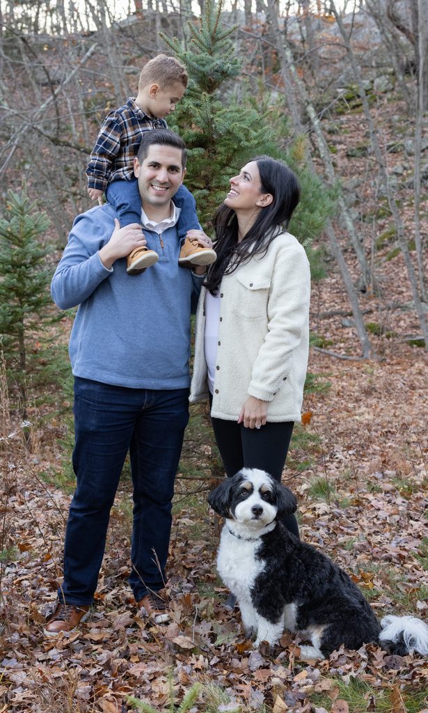 Family portraits showcase parents and children enjoying Christmas tree farm mini sessions in West Milford, New Jersey.