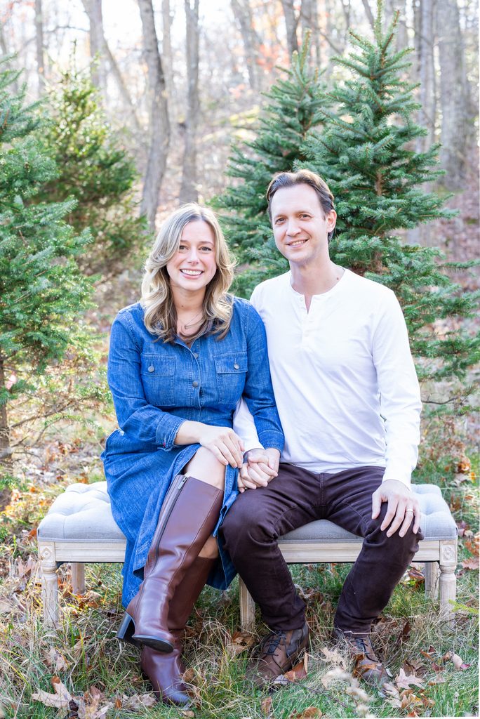 Couples portraits showcase parents and children enjoying Christmas tree farm mini sessions in West Milford, New Jersey.